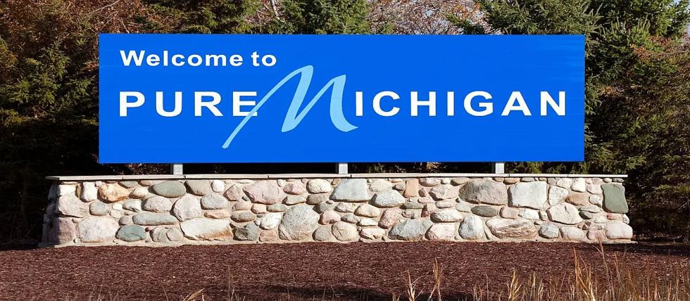 A Welcome to Michigan sign along the highway