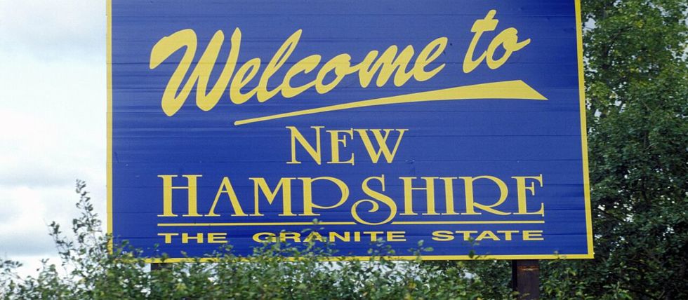 A Welcome to New Hampshire sign along the highway