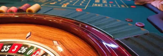 People betting on roulette at a casino table. Fake Mexican Casino Ponzi Scheme